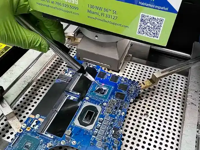 Technician cleaning a laptop