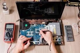 Technician cleaning a laptop