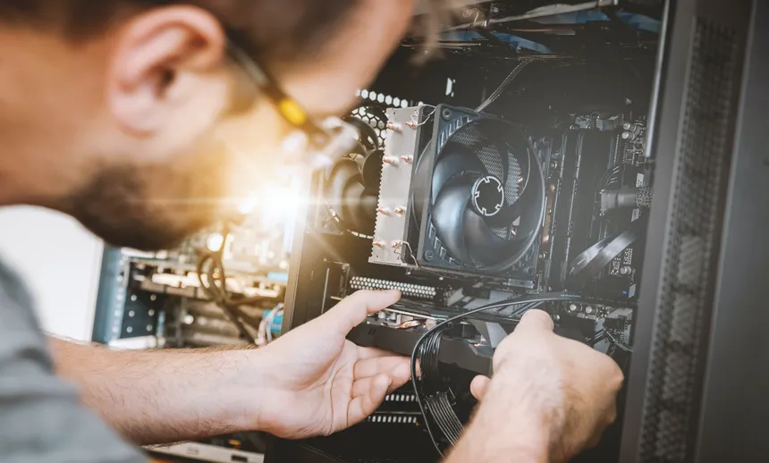 Technician cleaning a laptop